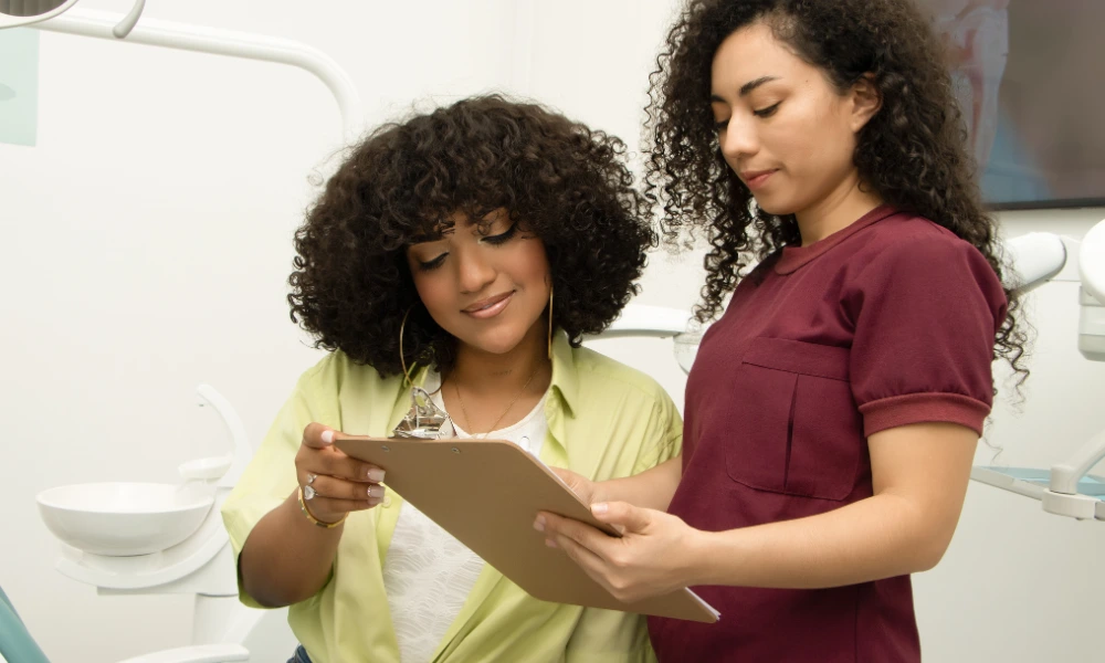 health-check-diagnosis A patient and a doctor look at a clipboard together