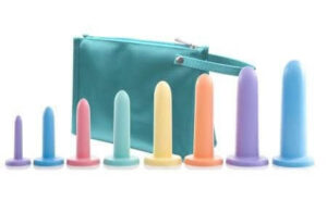 Green bag with a row of 8 various size dilators arranged from smallest to largest from left to right