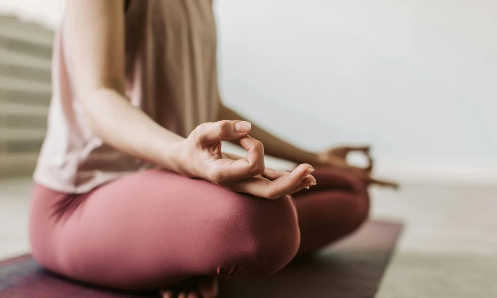 meditation A close up of someone sitting on a yoga mat and meditating