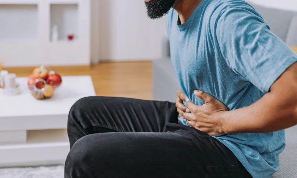 A man holding his stomach area in pain