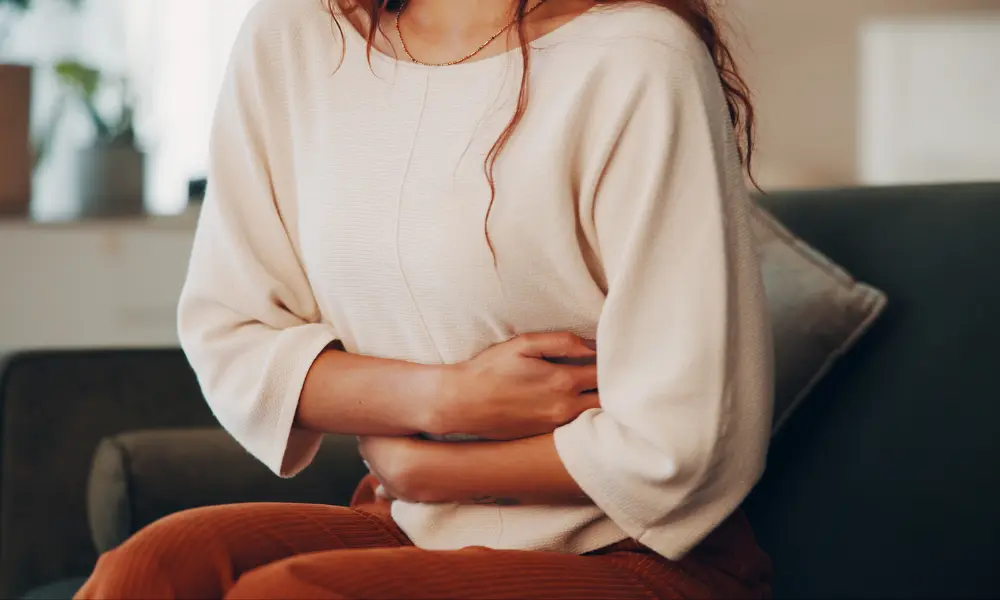 constipation Woman holding her stomach in discomfort