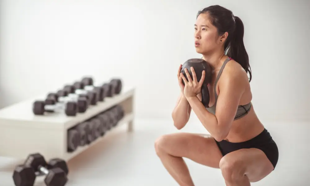 exercise A woman performs a weight training exercise