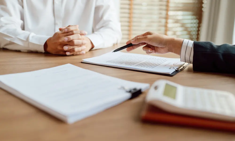 insurance-consultation two people at a table partake in a consultation