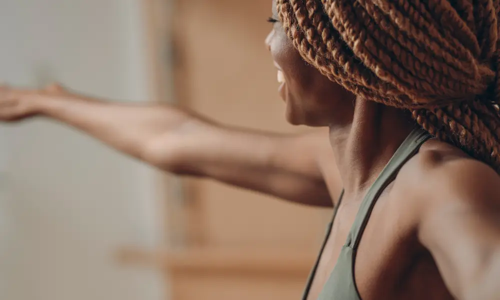 a close up of a person doing yoga and smiling