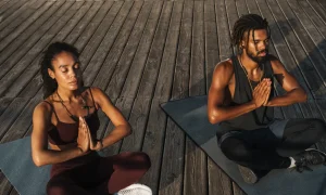 Two people doing yoga outside