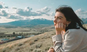A woman stands outside thinking hard about something